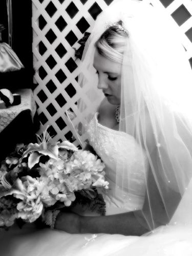 Bride wearing a white wedding dress holding a bouquet